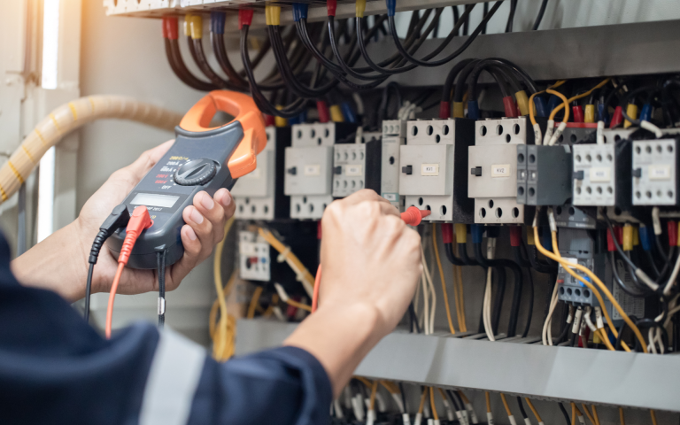 Professional electrician completing commercial electrical wiring installation safely